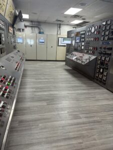 A control room with new light wood-look laminate flooring installed by Carpet Direct Brandon Burley in Muskogee, OK