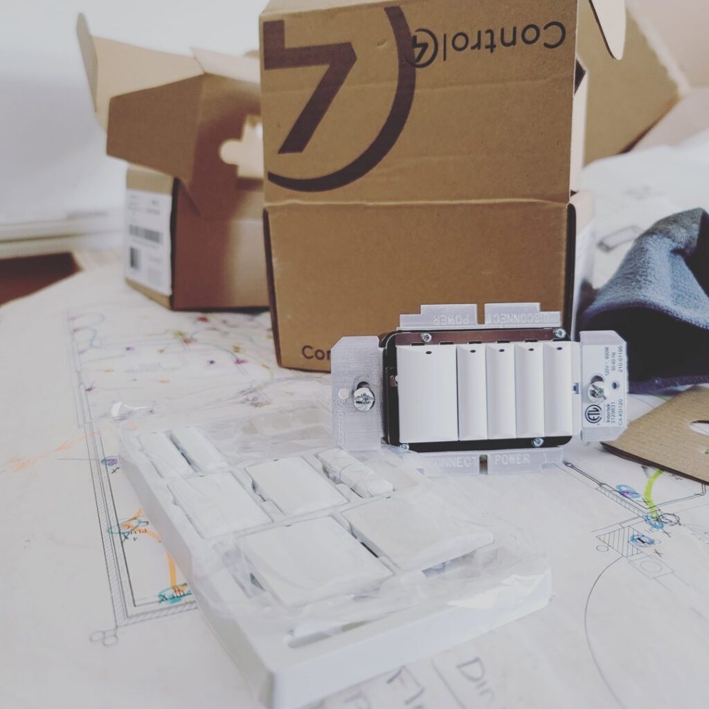 Control4 smart home electrical components and light switches laid out on blueprints by Corey N Craig Electric LLC in Charlotte, NC.