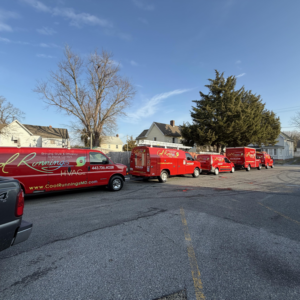 A fleet of red Cool Runnings HVAC LLC service vans parked in Salisbury, MD, ready for HVAC jobs.