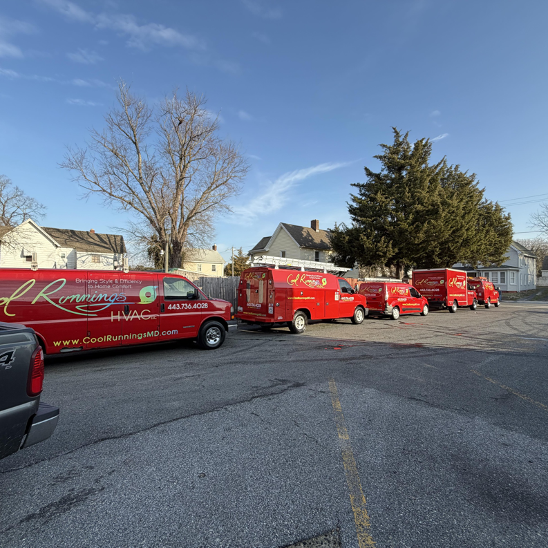 A fleet of red Cool Runnings HVAC LLC service vans parked in Salisbury, MD, ready for HVAC jobs.
