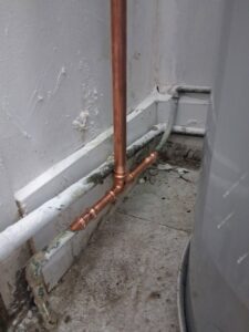 Newly installed copper piping connected to a water heater, demonstrating plumbing expertise by Wright Mechanical in Ypsilanti, MI.