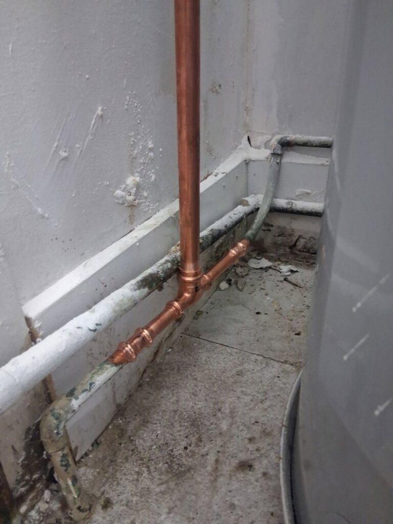 Newly installed copper piping connected to a water heater, demonstrating plumbing expertise by Wright Mechanical in Ypsilanti, MI.
