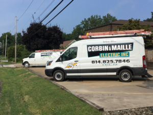 Two Corbin & Maille, Inc service vans with ladders, ready for electrician jobs in Erie, PA.