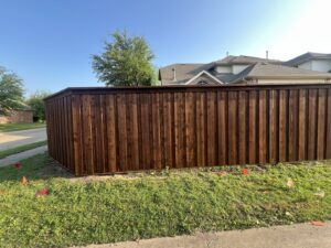 A newly installed wooden privacy fence expertly built around a property corner by Reliable Texas Fencing in Fort Worth, TX.