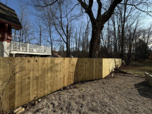 A corner section of a sturdy wood privacy fence installed by Red Lake Fencing & Construction for a property in Springfield, MA.