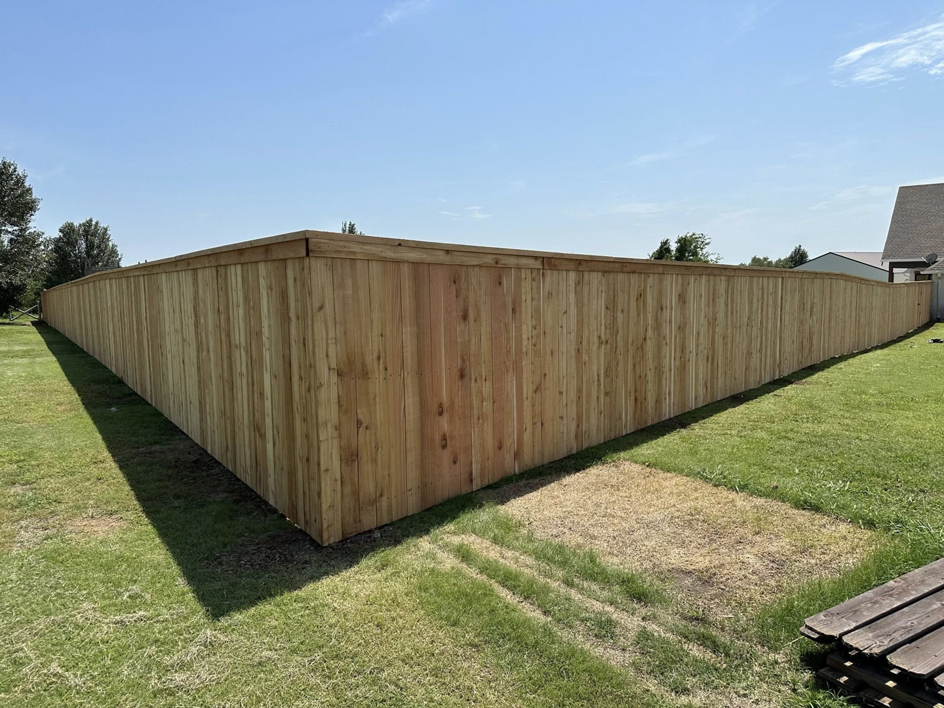 A corner section of a newly installed wood privacy fence by DB Construction in Fort Smith, AR.