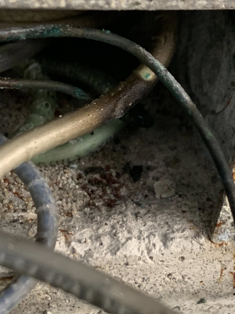 Close-up of corroded electrical wires, showing a repair need by Hulett Electric & Father in Shaftsbury, VT.