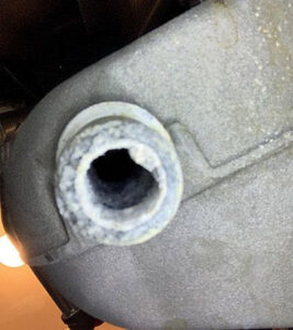 Close-up of a corroded heating system pipe connection needing repair by Q1 Mechanical Services, LLC in Wasilla, AK