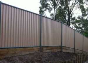 A corrugated metal privacy fence installed on a sloped terrain by Fence Company Chicago in Chicago, IL