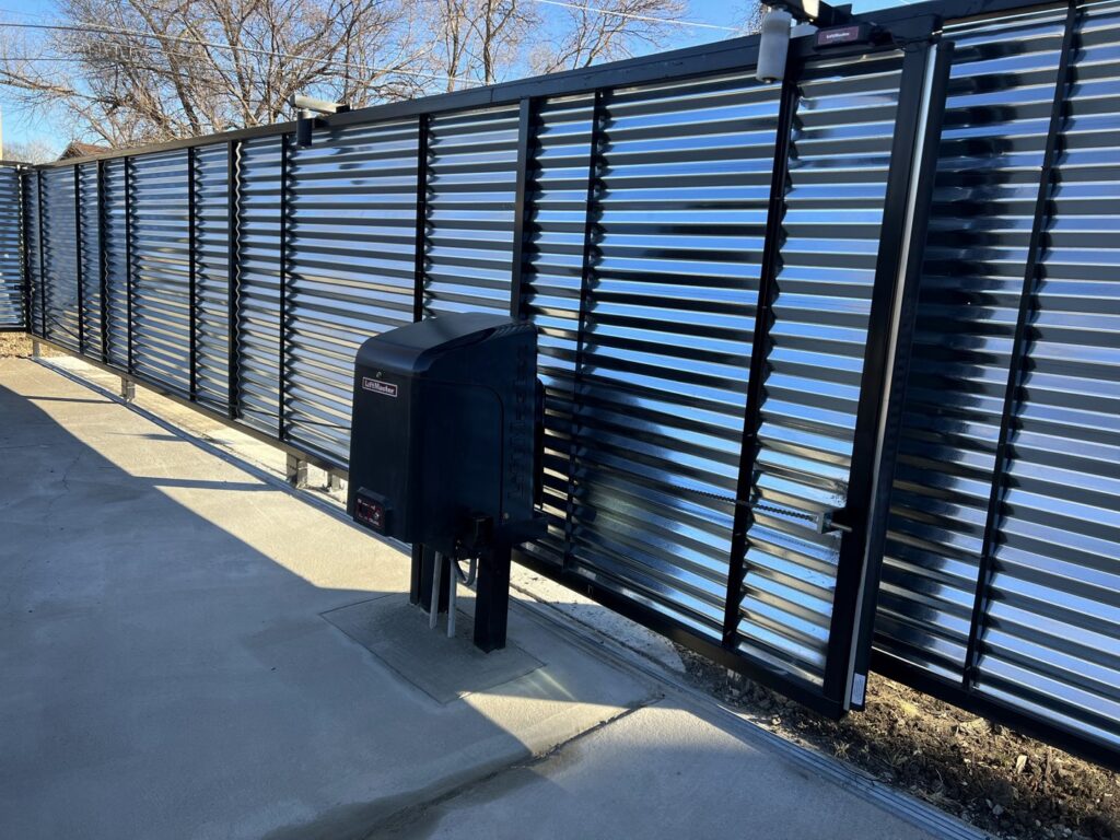 A corrugated metal sliding gate installation by Brothers Gate Operators and Services LLC in Olathe, KS.