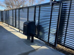 A corrugated metal sliding gate installation by Brothers Gate Operators and Services LLC in Olathe, KS.