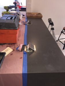 Installation of countertop pop-up electrical outlets with tools and protective covering by MG ELECTRIC INC in Lauderhill, FL