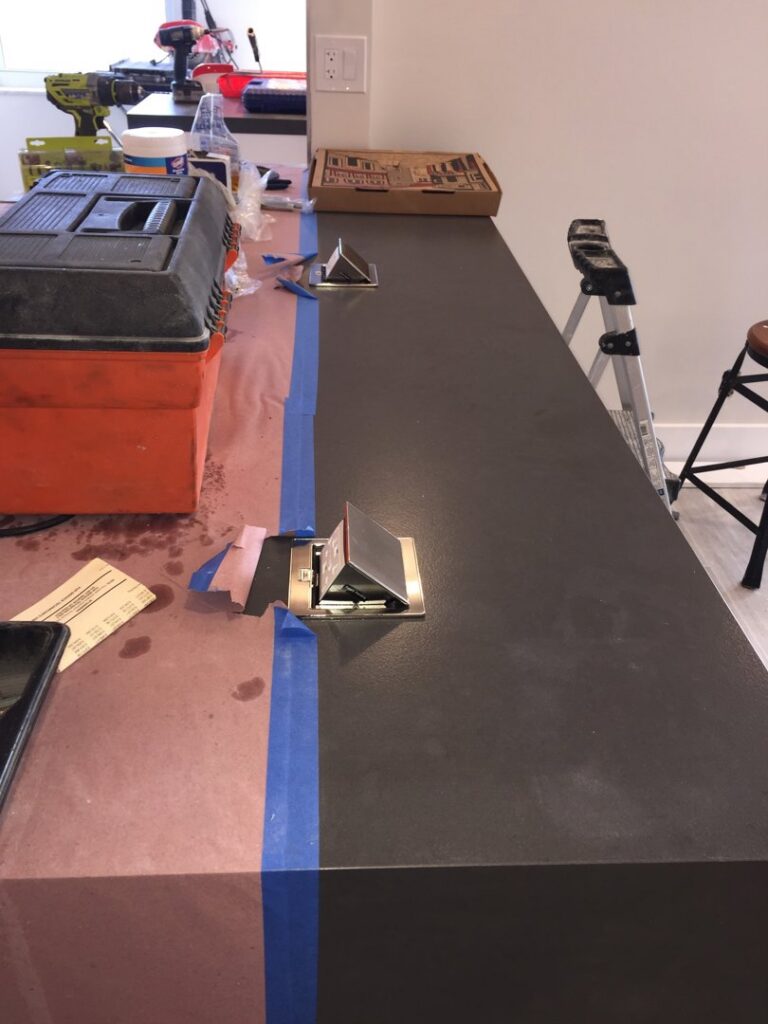 Installation of countertop pop-up electrical outlets with tools and protective covering by MG ELECTRIC INC in Lauderhill, FL