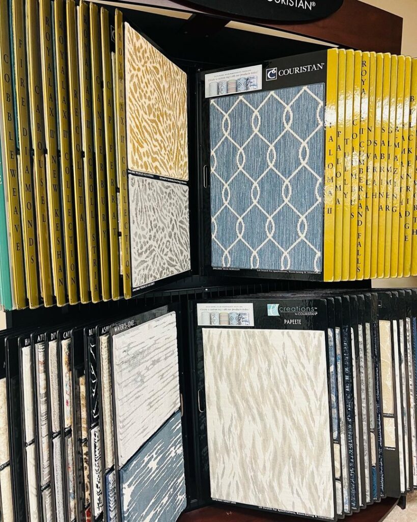 Couristan carpet samples with various patterns and colors displayed at All Surfaces Wholesale in Houston, TX.