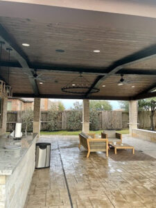 A covered patio with modern recessed lighting and ceiling fan installations completed by LOJ Electric, LLC in Houston, TX.