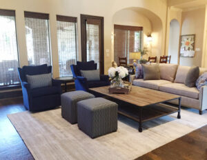 A cozy living room featuring a light-colored area rug, showcasing a completed project by Dallas Rugs in Dallas, TX.