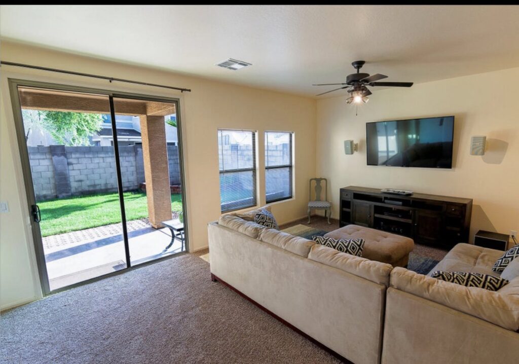 A cozy living room showcasing a fresh brown carpet installation by Arizona Flooring wholesale center in Chandler, AZ.