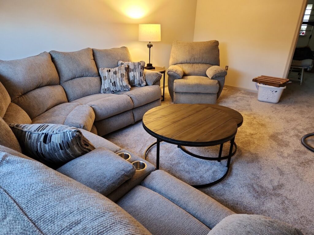 A cozy living room featuring a new light-colored carpet installed by Jordan's Flooring in Martinsburg, WV