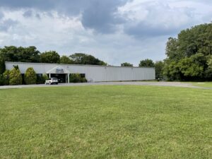 A wide exterior view of the Craft Rug Mills building with a large lawn in Easton, PA.