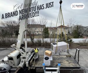 A crane delivering a brand new rooftop HVAC unit for Empire Tech, Inc. installation in Schaumburg, IL.