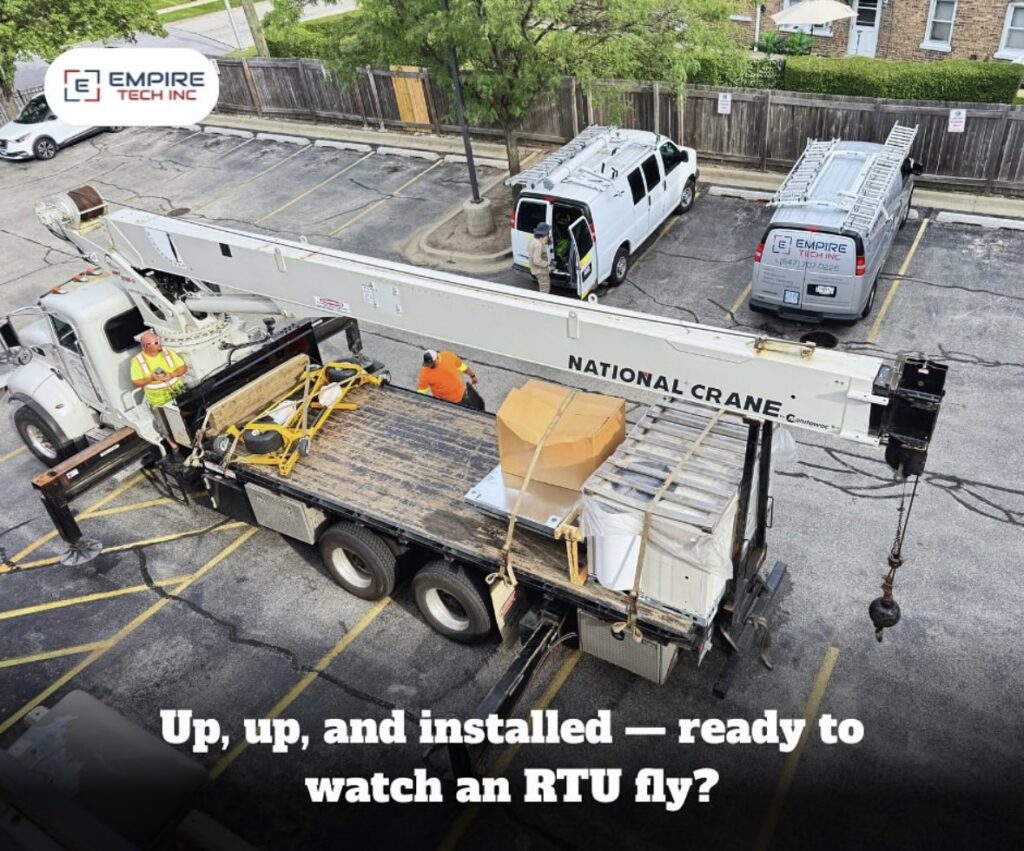An aerial view of a crane installing a rooftop HVAC unit for Empire Tech, Inc. in Schaumburg, IL.