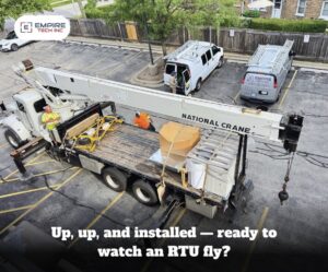 An aerial view of a crane installing a rooftop HVAC unit for Empire Tech, Inc. in Schaumburg, IL.