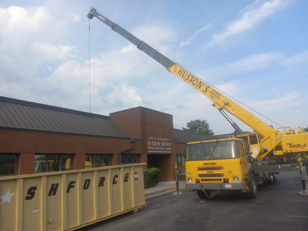 A crane lifting a new commercial HVAC unit onto a rooftop by Major Air HVAC Services in Salisbury, MD.