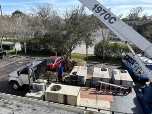 A crane lifting a large commercial HVAC unit onto a rooftop for installation by Air Zero in Largo, FL