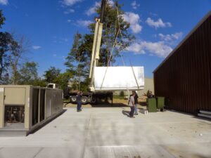 A crane lifting a large HVAC component during an installation project by AireCom HVAC in Columbus, OH.