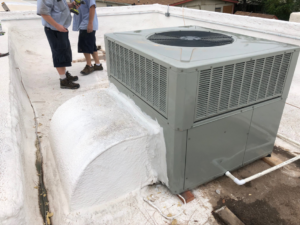 A crane lifting an HVAC unit for installation by Schiller Heating & Cooling in Tempe, AZ.