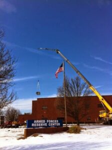 A crane lifting a large HVAC unit for commercial installation at the Armed Forces Reserve Center by KATS Heating & Cooling in La Grange Park, IL.