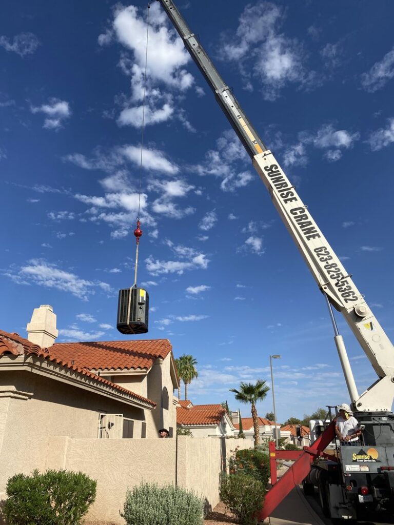 A crane lifting an HVAC unit for installation over a residential property by Mountainside Air in Phoenix, AZ.