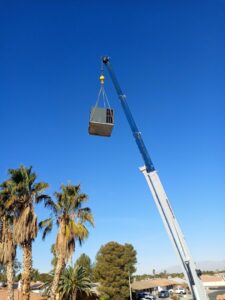 A crane lifting an HVAC unit for rooftop installation by Expert Air Conditioning & Heating in Las Vegas, NV.