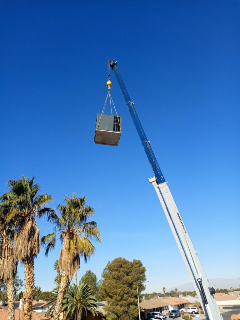 A crane lifting an HVAC unit for rooftop installation by Expert Air Conditioning & Heating in Las Vegas, NV.