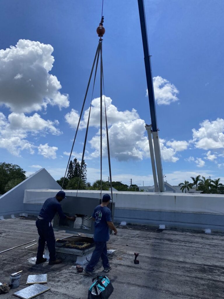 A crane lifting an HVAC unit onto a rooftop for installation by T&D Air Conditioning in Fort Lauderdale, FL.