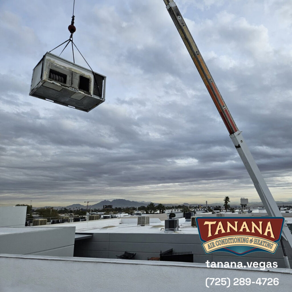 A crane lifting an HVAC unit onto a commercial rooftop for installation by Tanana Air Conditioning & Heating in Las Vegas, NV.