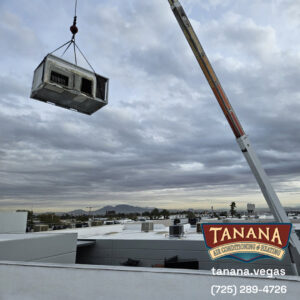 A crane lifting an HVAC unit onto a commercial rooftop for installation by Tanana Air Conditioning & Heating in Las Vegas, NV.