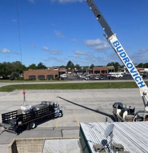 A crane lifting new HVAC units onto a truck for Leiber Heating & Air Conditioning in St Charles, MO.