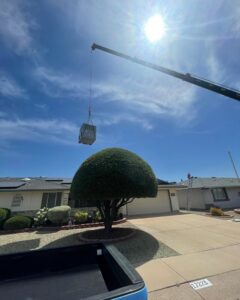 A crane lifting a new HVAC unit onto a residential roof for installation by AZ Perfect Comfort in Phoenix, AZ.