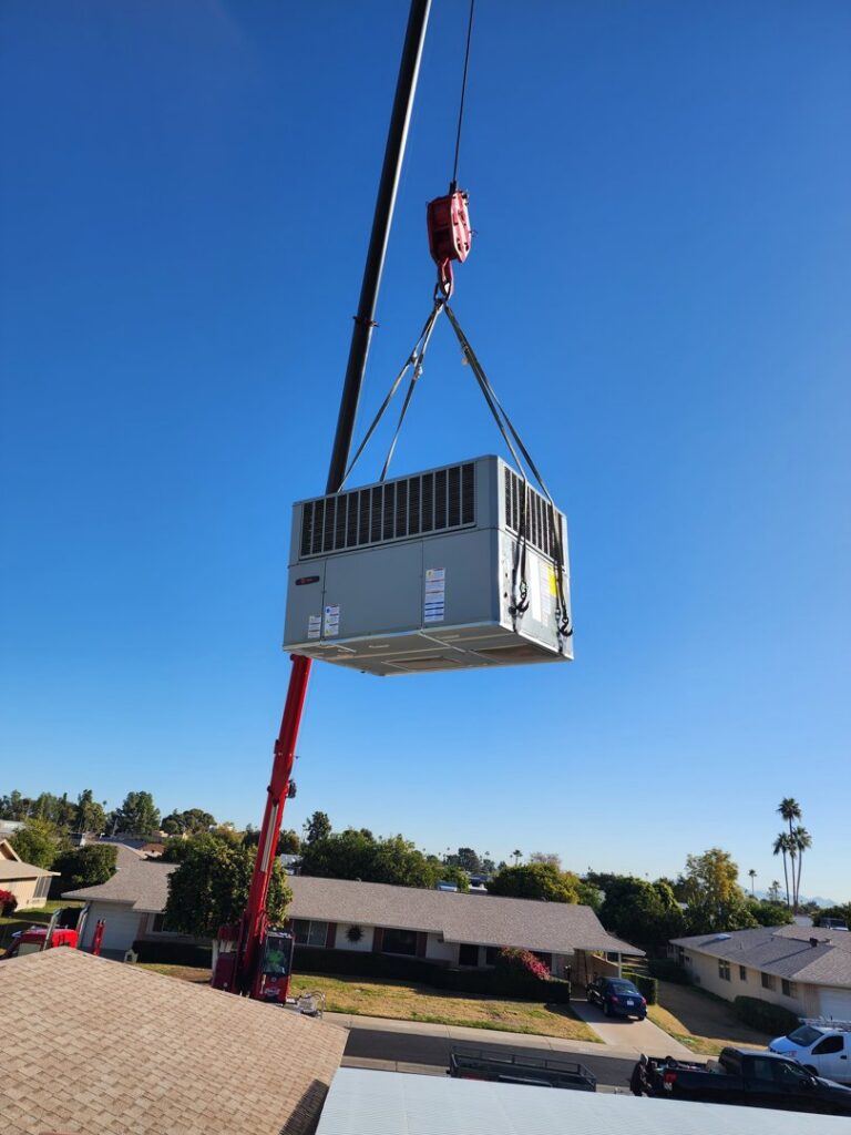 A crane lifting a new HVAC unit over a residential neighborhood for installation by State 48 Home Comfort LLC in Peoria, AZ.