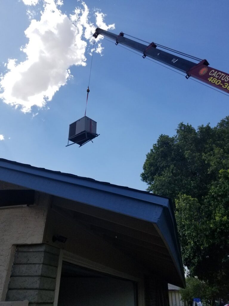 A crane lifting a new rooftop HVAC unit for installation by A+ Air and Aeroseal in Scottsdale, AZ.