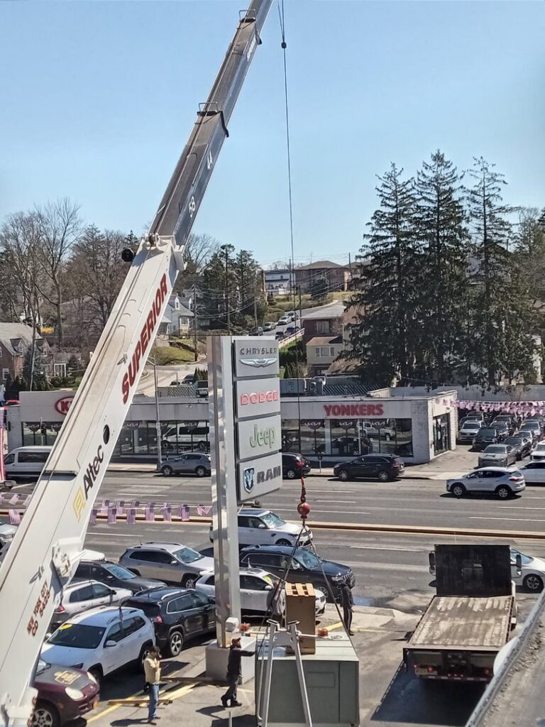 A crane lifting a new rooftop HVAC unit into place for Enviromax Heating & Cooling in Peekskill, NY.