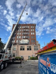 A crane lifting a new rooftop HVAC unit into place for Southern Comfort Heating & Cooling in Lexington, KY