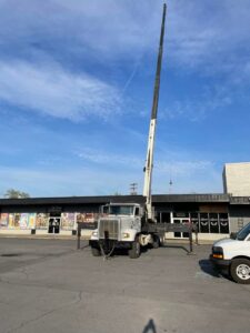 A crane truck positioned for a commercial HVAC installation or removal job by Trusted HVAC in Martinsburg, WV