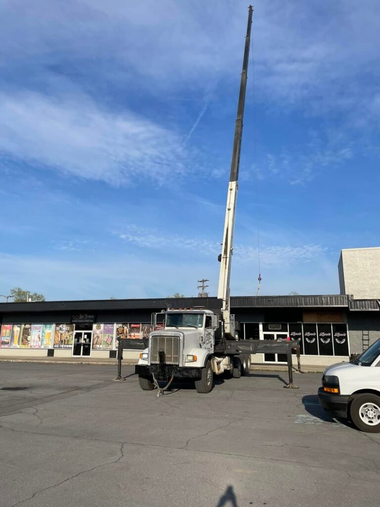 A crane truck positioned for a commercial HVAC installation or removal job by Trusted HVAC in Martinsburg, WV