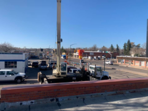 A crane truck positioned for lifting an HVAC unit during installation by 413 Services in Piedmont, SD