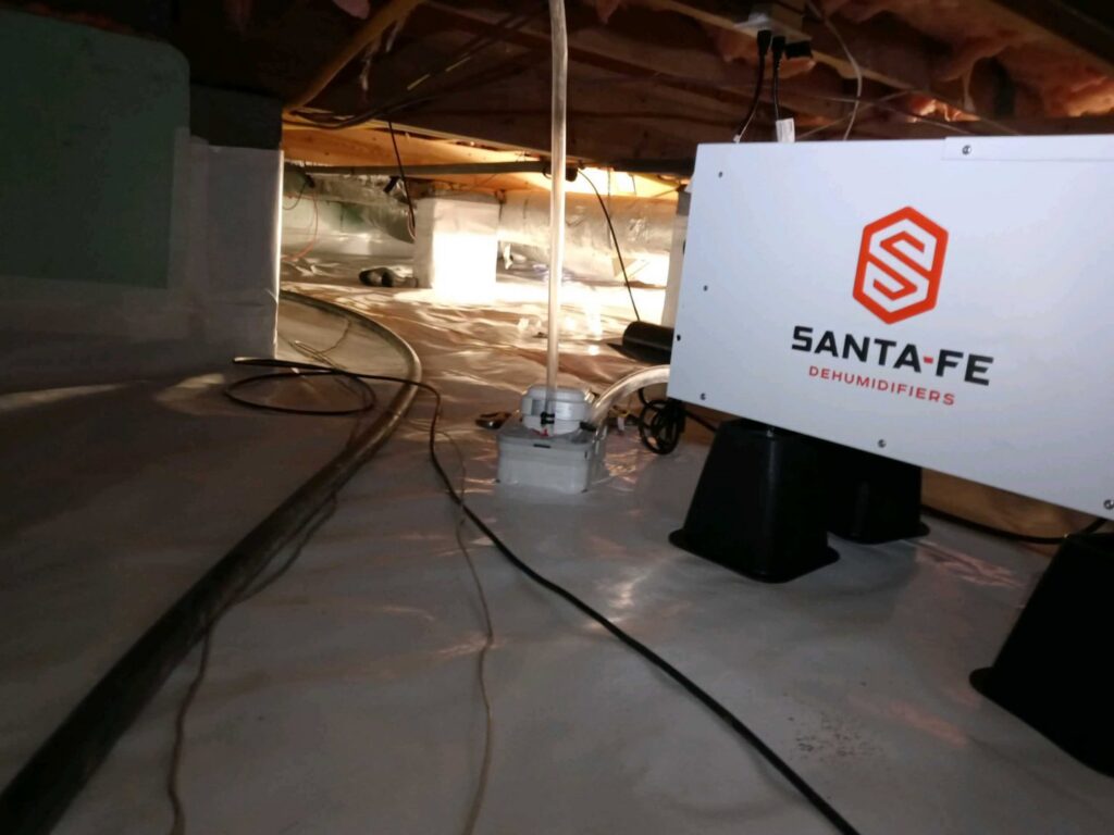 A crawl space with a Santa Fe dehumidifier and vapor barrier installed by Global Green Termite & Pest Control LLC in Hampton, VA.