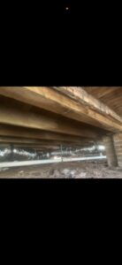 Insulated HVAC ductwork visible in a crawlspace under a house, installed by Budget Heating and Air in Mobile, AL.