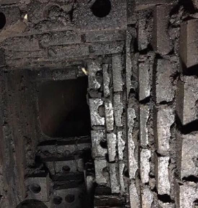 A heavily creosote-laden and damaged chimney flue, indicating a necessary sweep and repair by Chimney Care experts in Doraville, GA.
