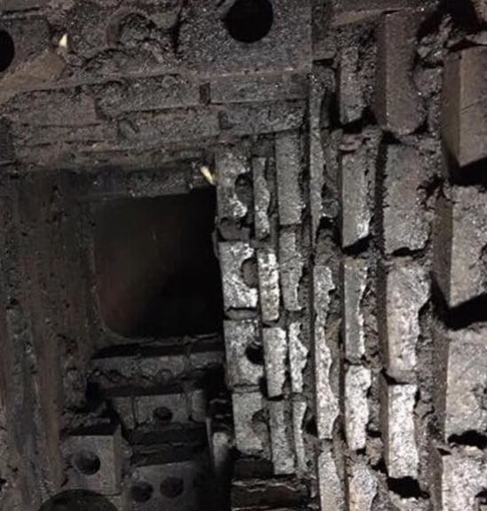 A heavily creosote-laden and damaged chimney flue, indicating a necessary sweep and repair by Chimney Care experts in Doraville, GA.